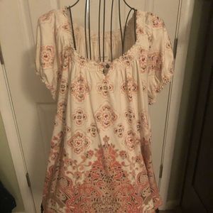 Beige shirt with orange and brown print.